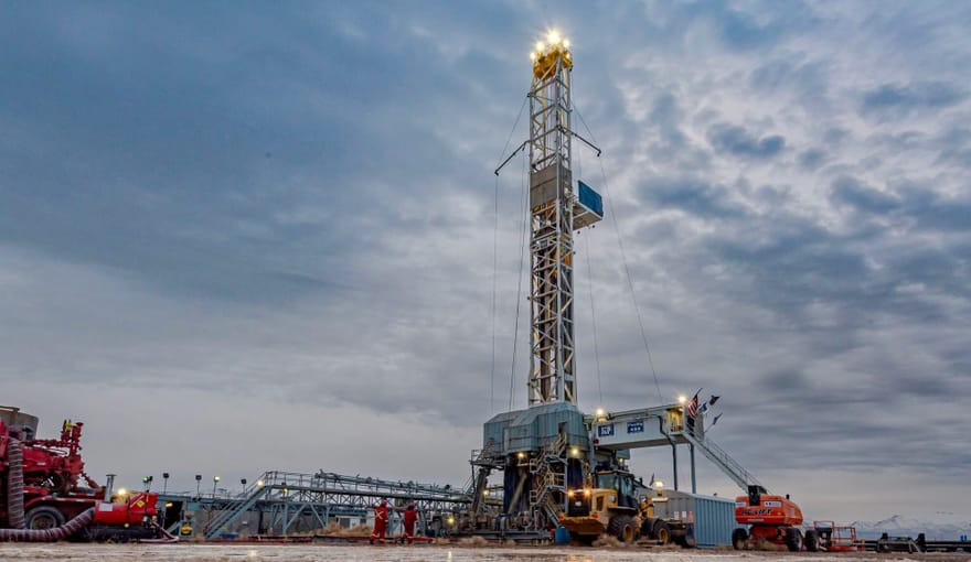 Drilling equipment rises against a cloudy sky