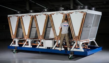 A person stands on a large piece of industrial equipment