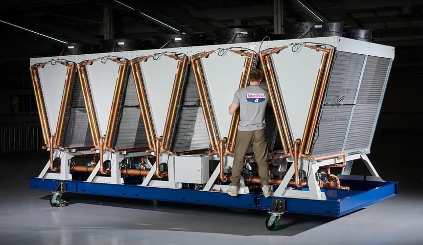 A person stands on a large piece of industrial equipment