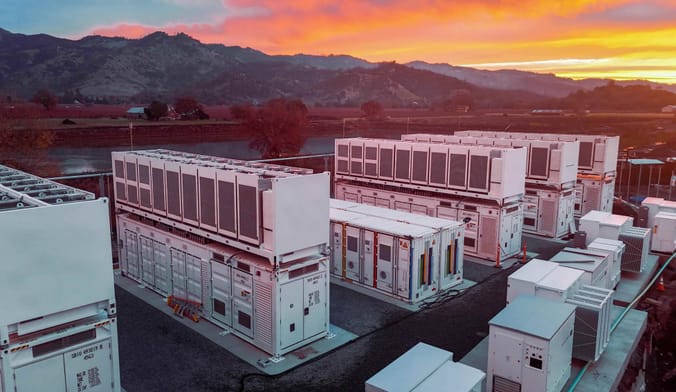 white industrial boxes against a sunset
