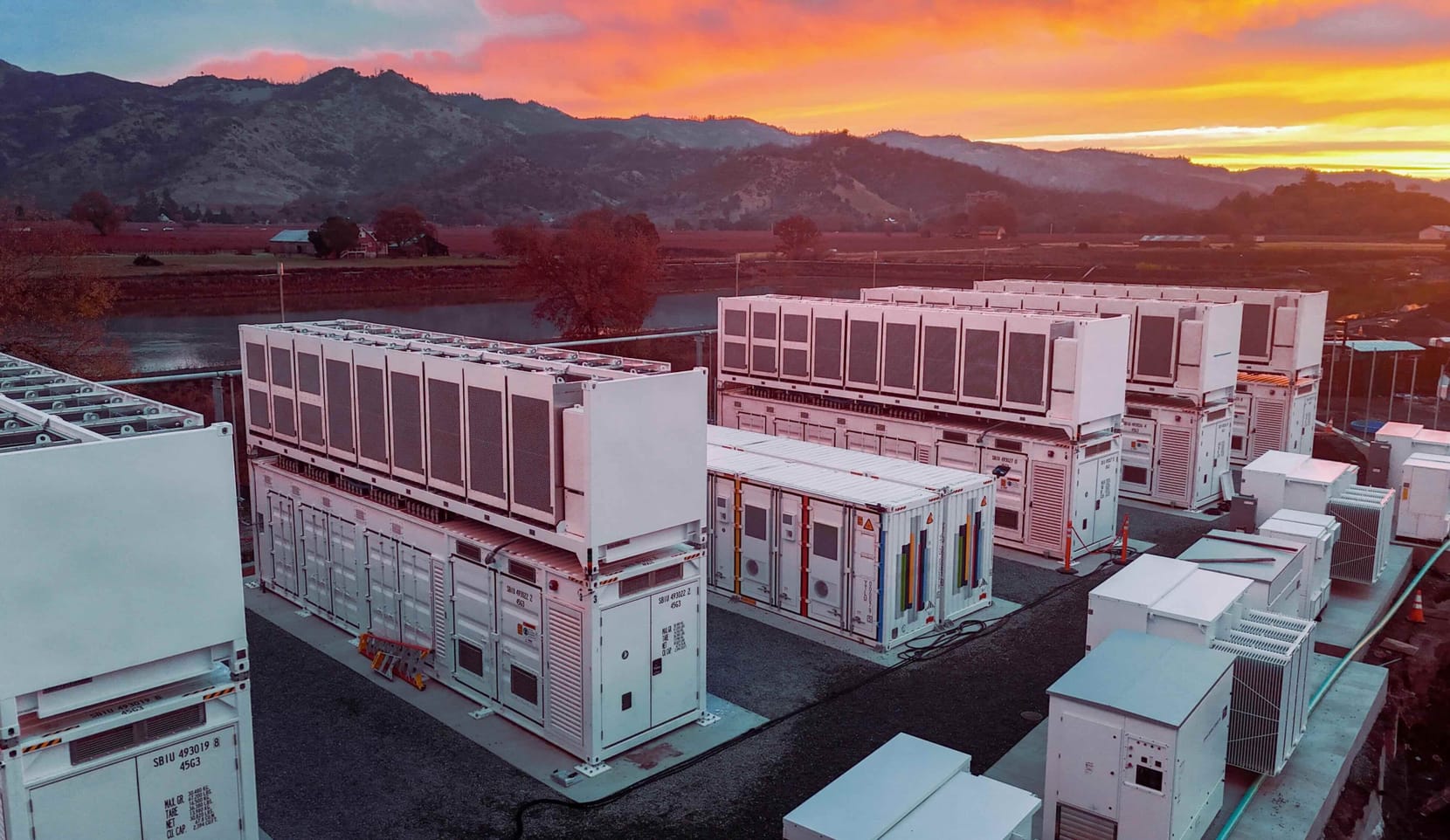 white industrial boxes against a sunset