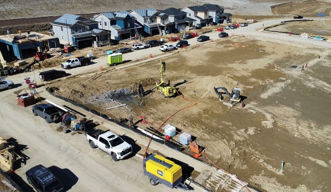 Drilling rig drills boreholes for Dandelion Energy's ground-source geothermal systems being built into new homes from Lennar