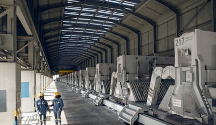 Two people walk in a factory