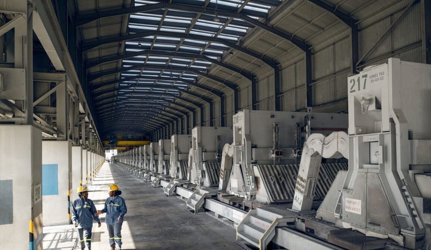 Two people walk in a factory