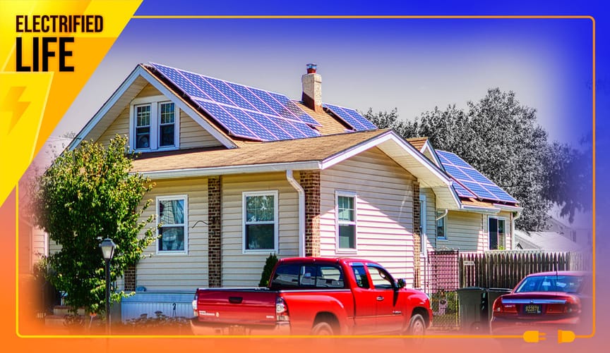 House with rooftop solar panels and red pickup truck parked out front