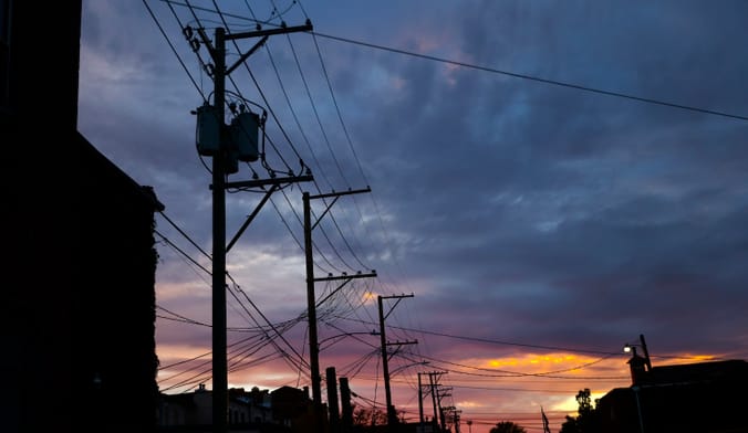 Power lines silhouetted against the sky at sunset