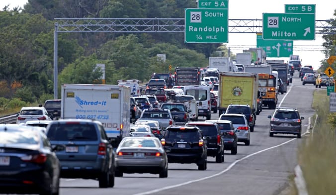 Multiple lanes of a highway filled with cars and trucks.
