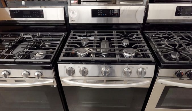 Three new gas stoves lined up next to one another