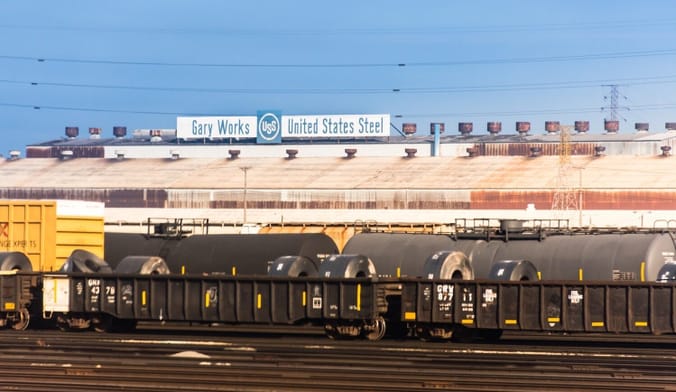 An industrial facility topped by a sign that reads "Gary Works United States Steel"