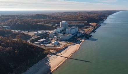 An industrial complex alongside a large body of water