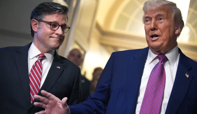 Two people wearing suits walk beside one another