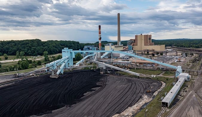 J.H. Campbell coal-fired power plant with pile of coal in front