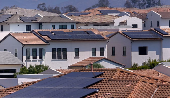 Roofs of homes with black solar panels on top
