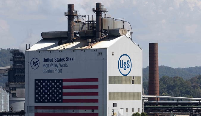 The Clairton Coke Works plant with U.S. Steel logo and American flag on the side wall.