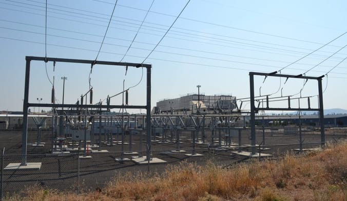 Power lines in front of a large boxy building