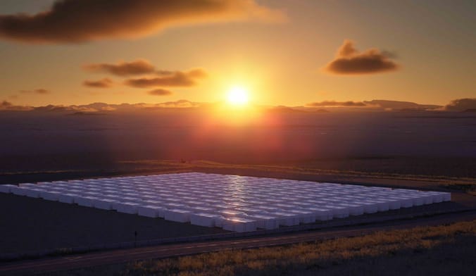 a square of big white boxes against the backdrop of a sunset