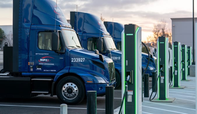 Electric trucks charging at NFI Industries’ truck-charging hub and warehouse in Ontario, California.