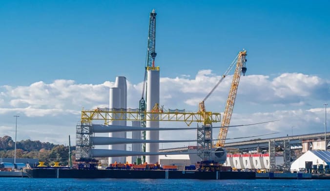 A pier with wind turbine equipment on a sunny day