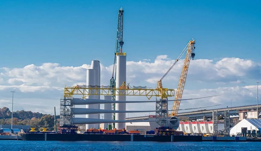 A pier with wind turbine equipment on a sunny day