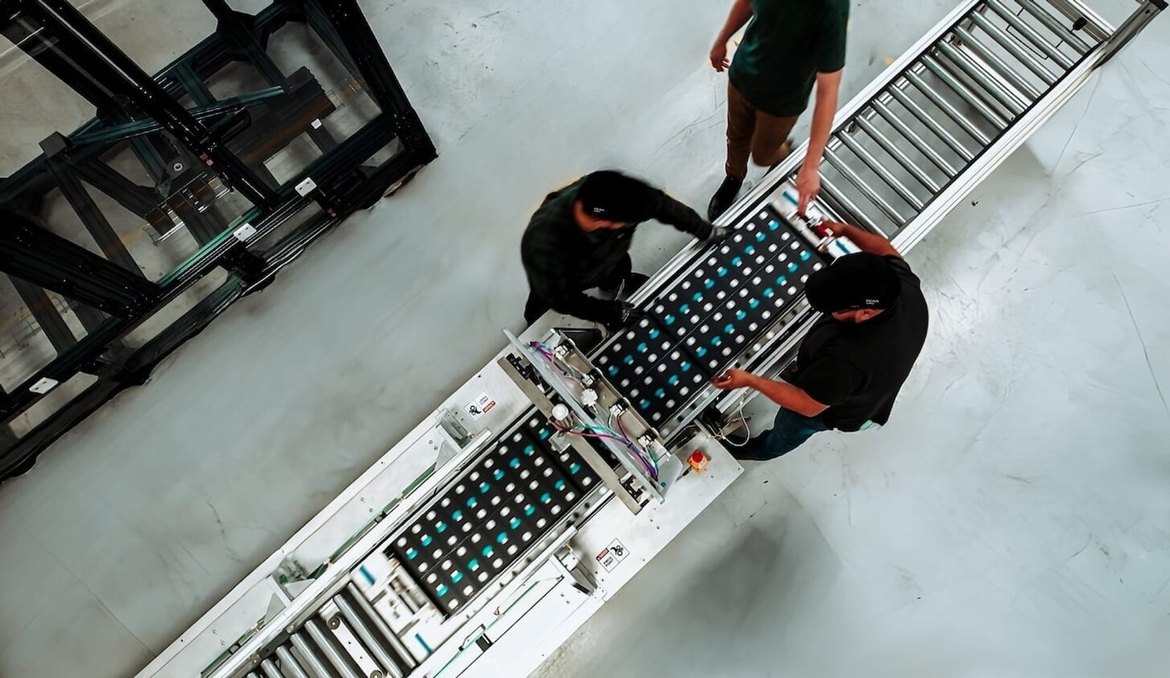 Aerial shot of people standing next to an assembly line