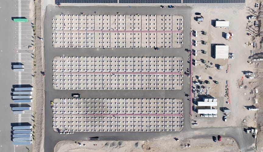 Aerial shot of array of boxes lined up in desert landscape