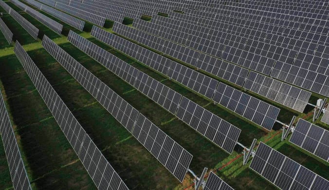Aerial shot of rows of solar panels in a field